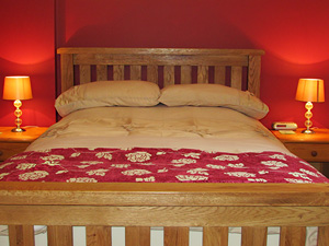 double bedroom with red wall